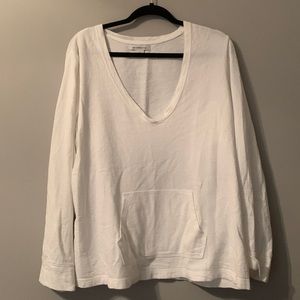 White cotton knit v neck shirt with front pocket.